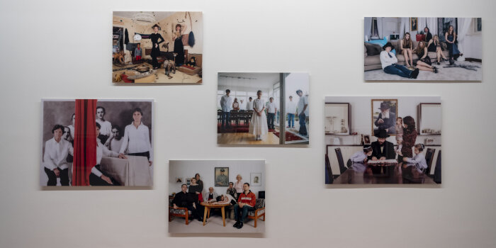 Blick auf eine Wand mit verschiedenen Fotografien von Familien