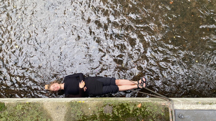 Eine Frau von oben fotografiert die über dem Wasser zu schweben scheint